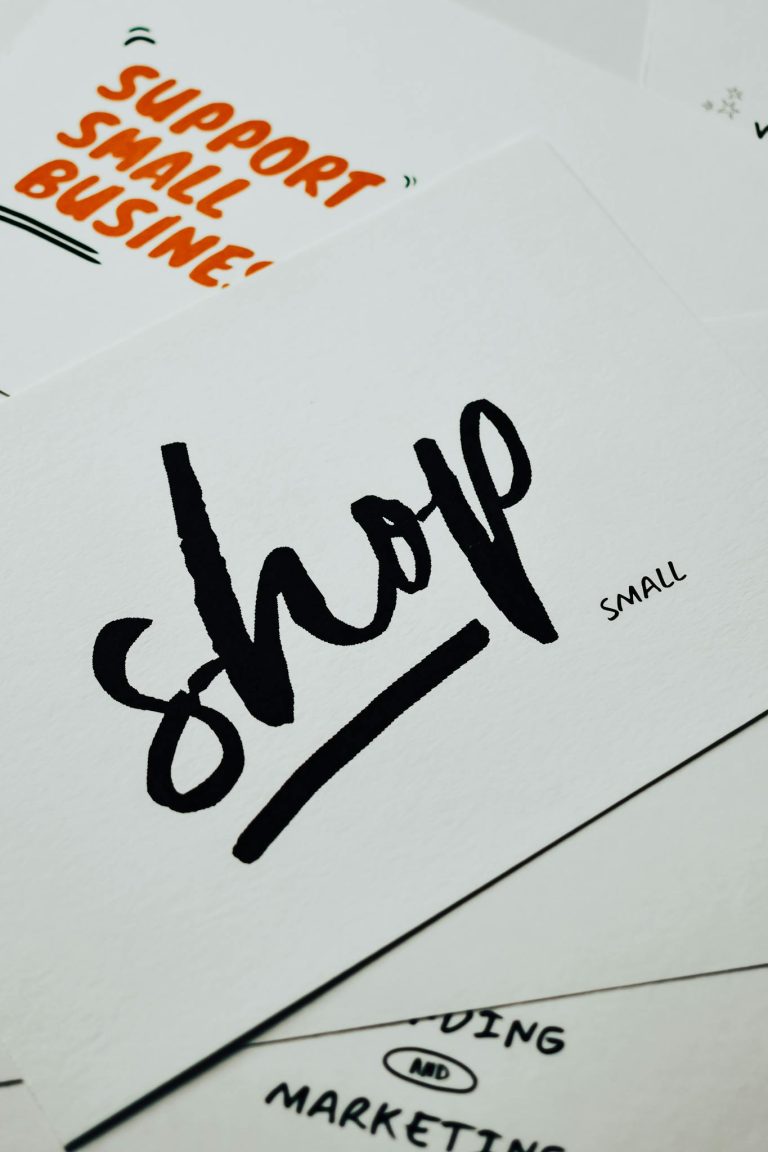 A close-up of a card with 'shop small' message promoting local small businesses.